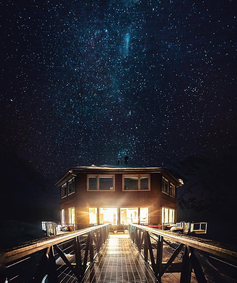 Starry night sky over Sheldon Chalet, Denali National Park, Alaska, USA