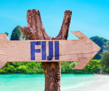 Fiji wooden sign with beach background