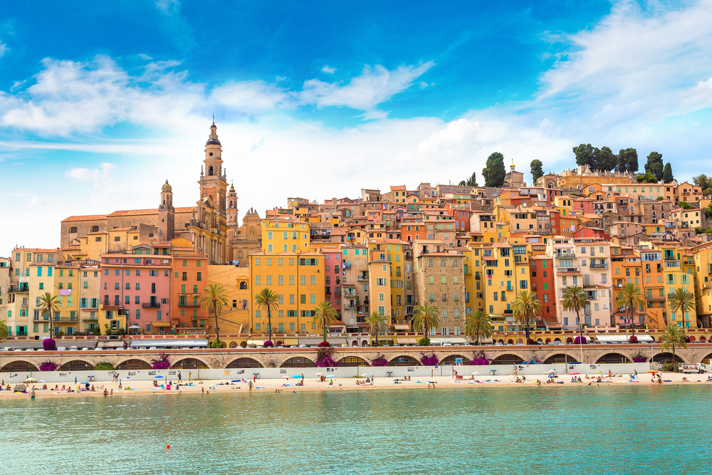 Colorful old town and beach in Menton on french Riviera in a beautiful summer day, France
